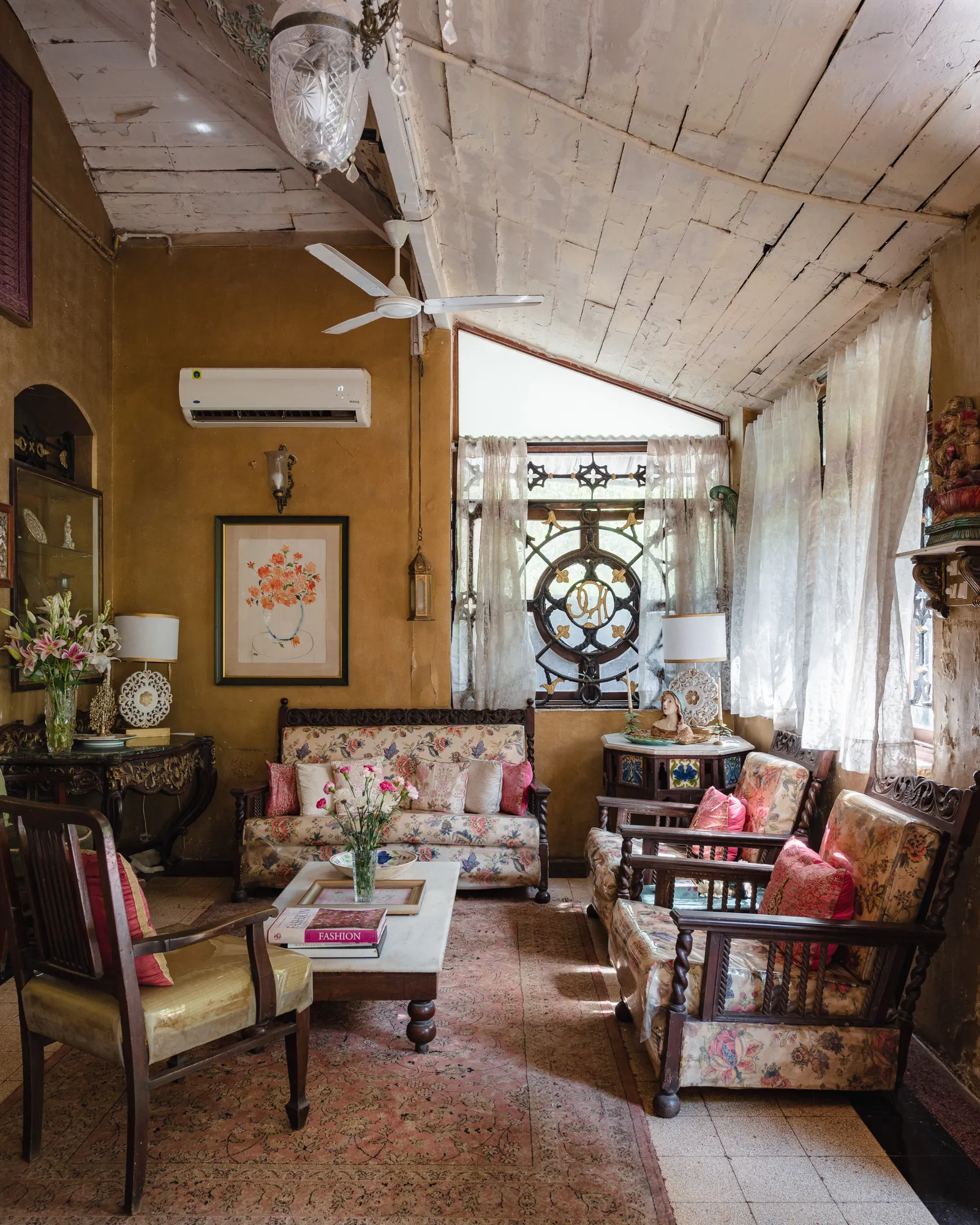 Image may contain Home Decor Furniture Table Appliance Ceiling Fan Device Electrical Device Coffee Table and Couch