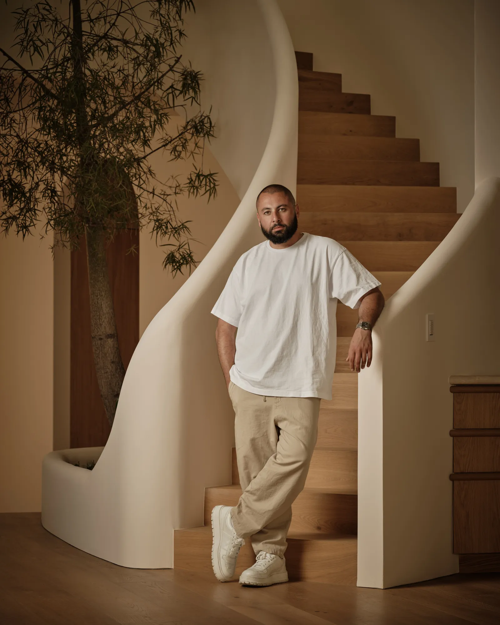 Image may contain Architecture Building House Housing Staircase Adult Person Clothing Pants Standing and Wood